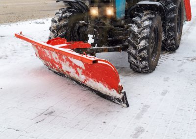 Snow removal vehicle removing snow. Tractor clears the way after heavy snowfall winter